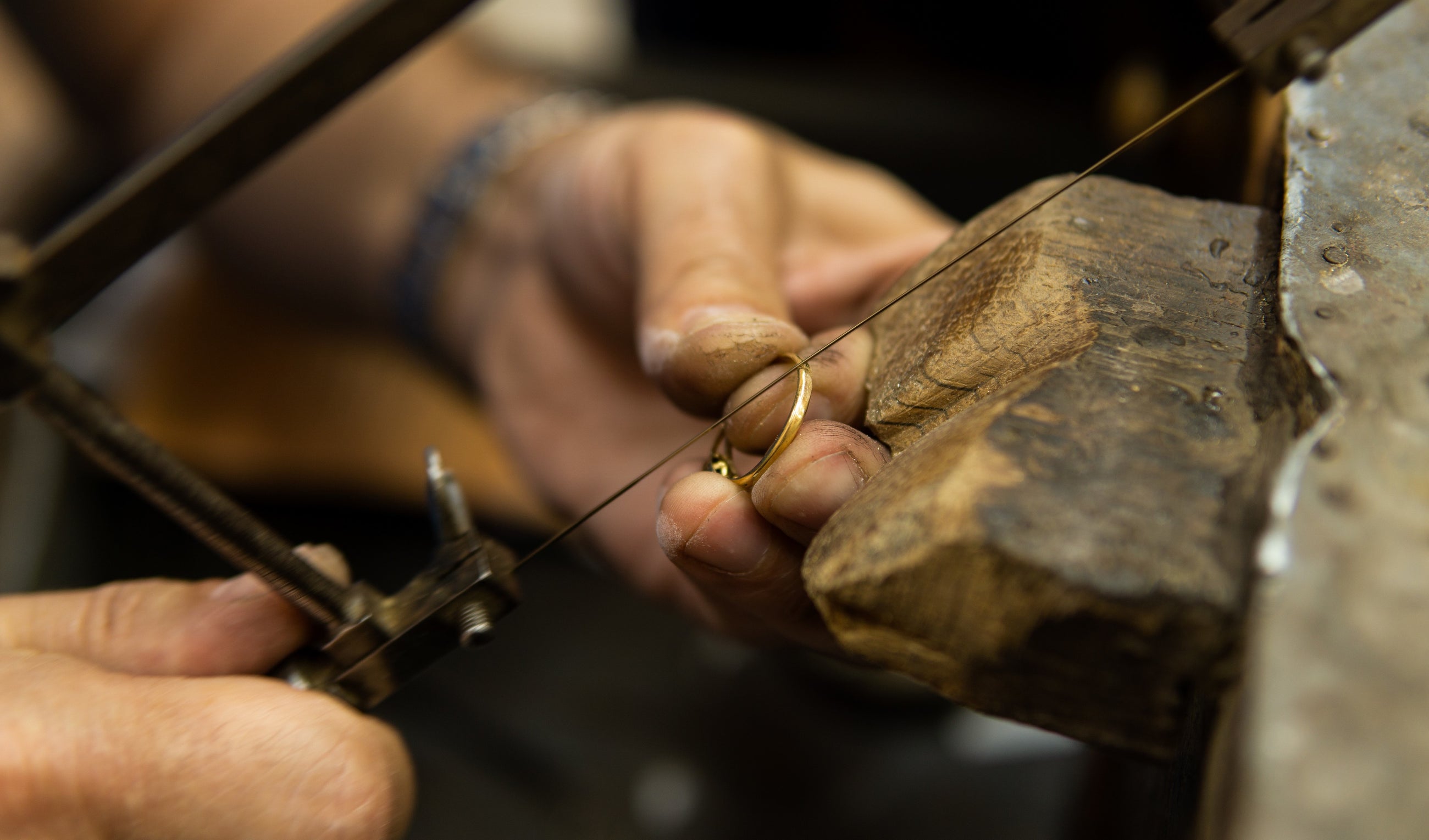An Independent jeweller making a gold diamond ring by hand.