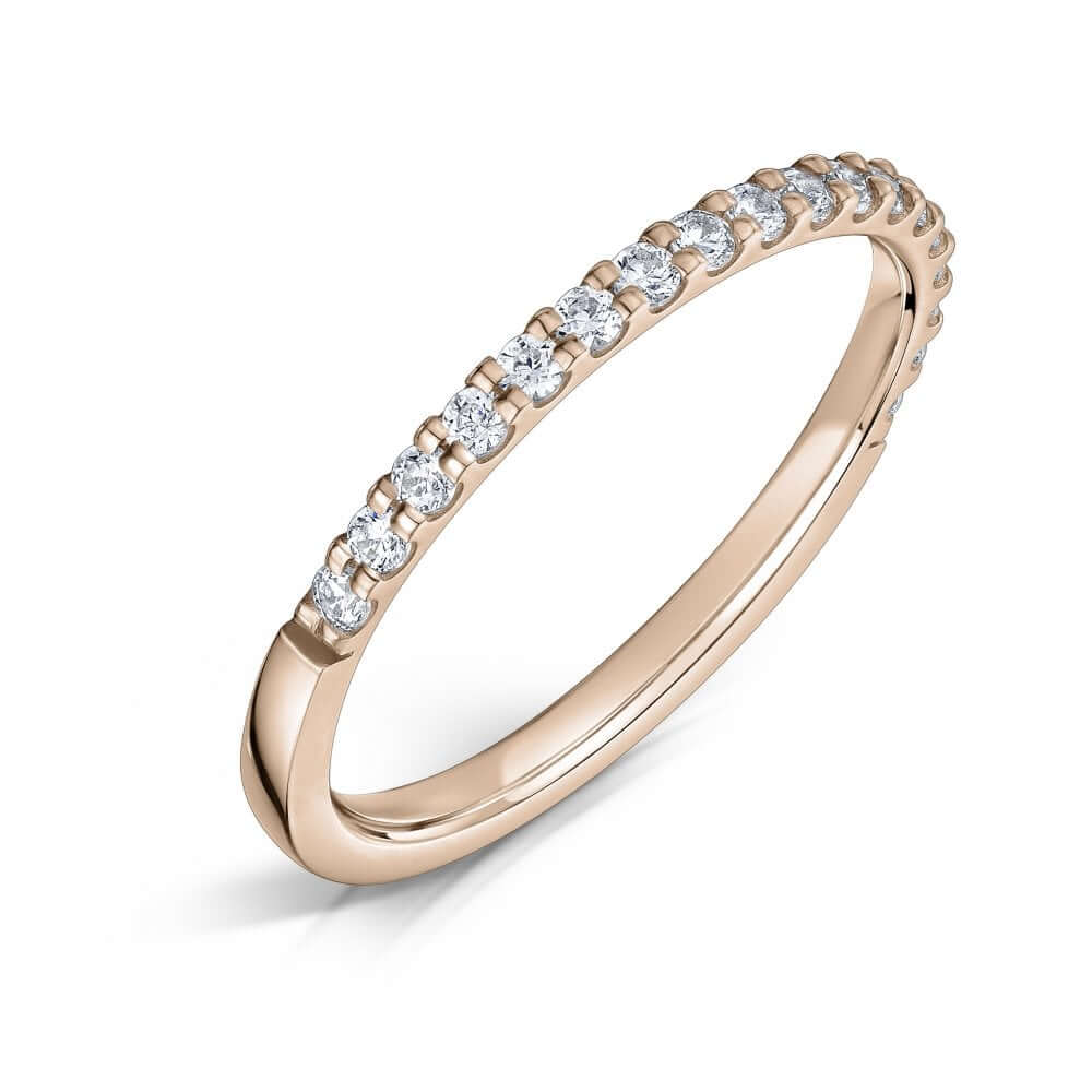 Rose Gold Eternity ring with 1.5mm diamonds half the way around on a white background.